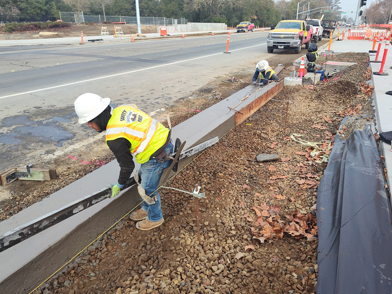 Pouring/finishing the new curbs and gutters along Fulton Road