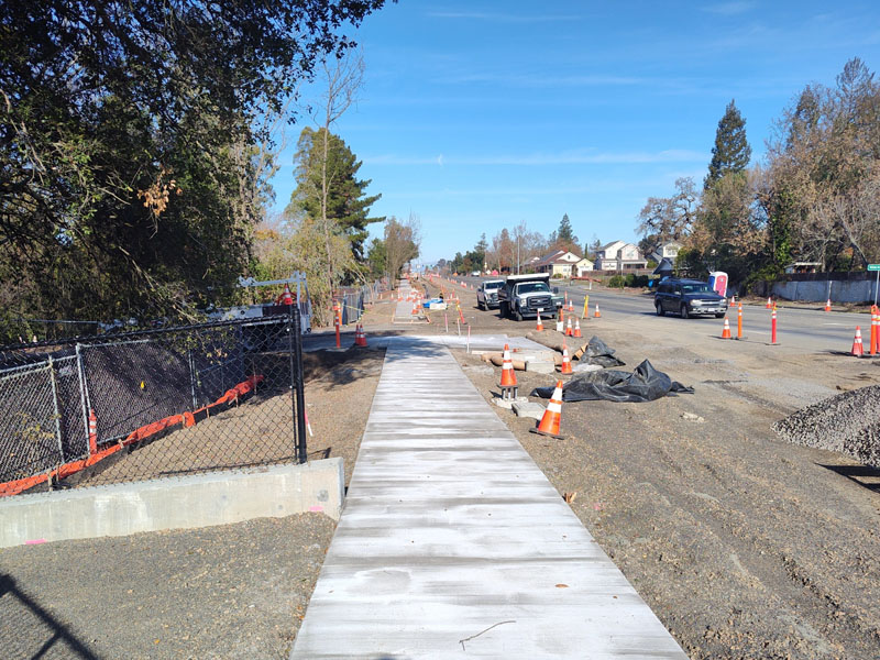 New sidewalk installation in front of the Forestview Creek path entrance