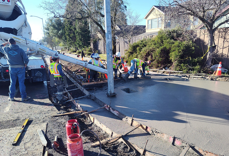 Pouring and forming concrete for a new sidewalk along Fulton Road