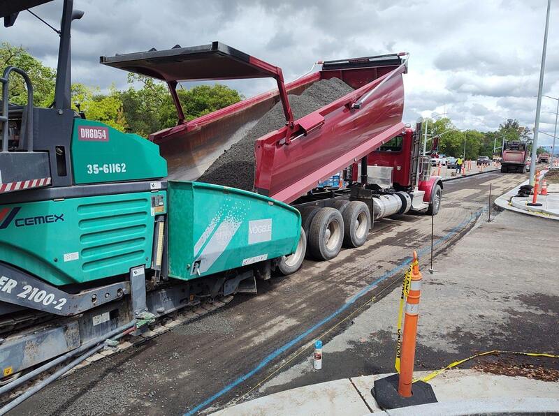 Loading concrete into the hopper of the RCC paving equipment