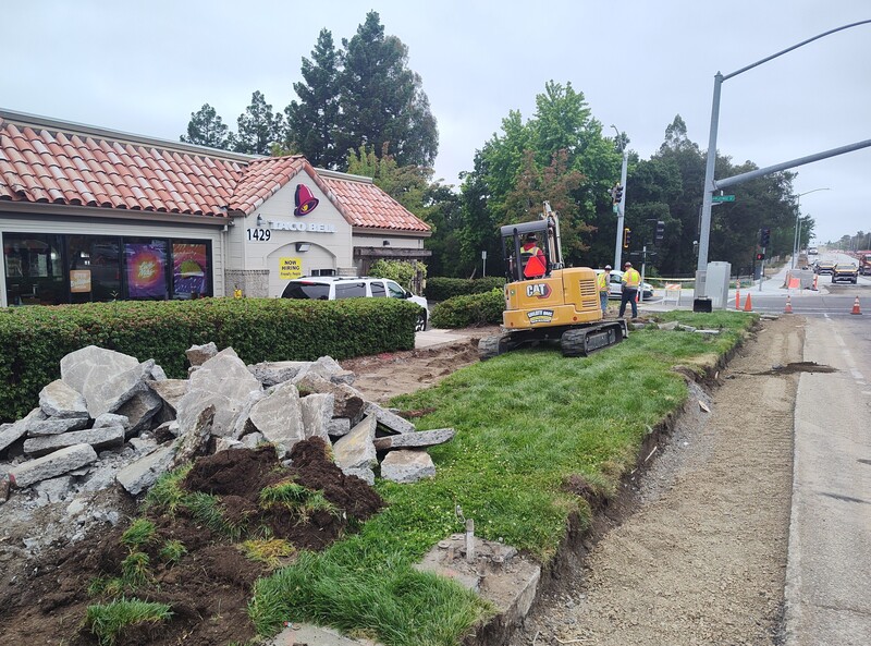 Removing the existing sidewalk in front of the Raley's Shopping Center