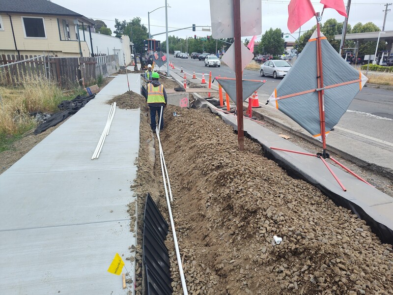 Installing irrigation lines along the new sidewalk on Fulton Road near the Guerneville Road intersection