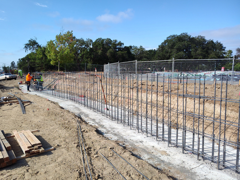 Preparing rebar to form a new retaining wall adjacent to Youth Community Park