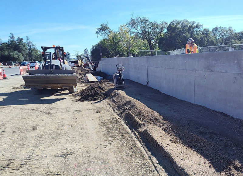 Finishing the new retaining wall in front of Youth Community Park