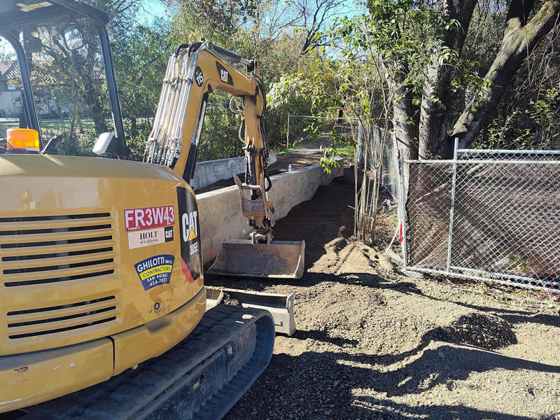 Backfilling behind a new retaining wall at the Forestview Creek path