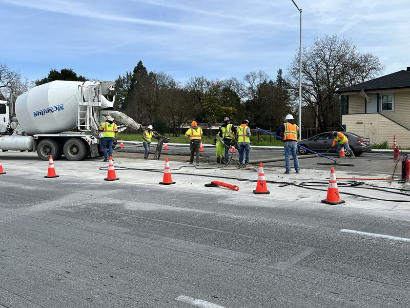 Pouring concrete to repair a section of the road surface