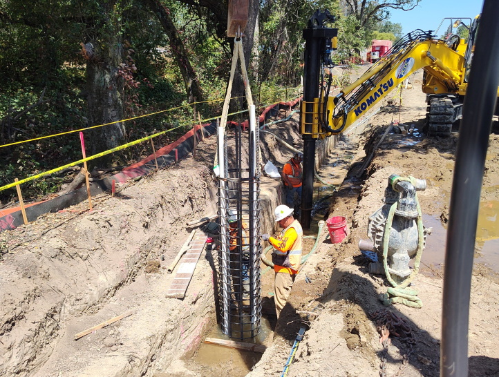 Installation of form for cement pile to support retaining wall